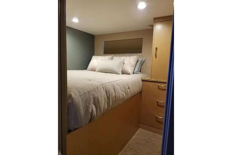 Slide: The Image of Cozy bedroom interior in 2017 Adonia 7518 RV with modern design and ample storage. - 20