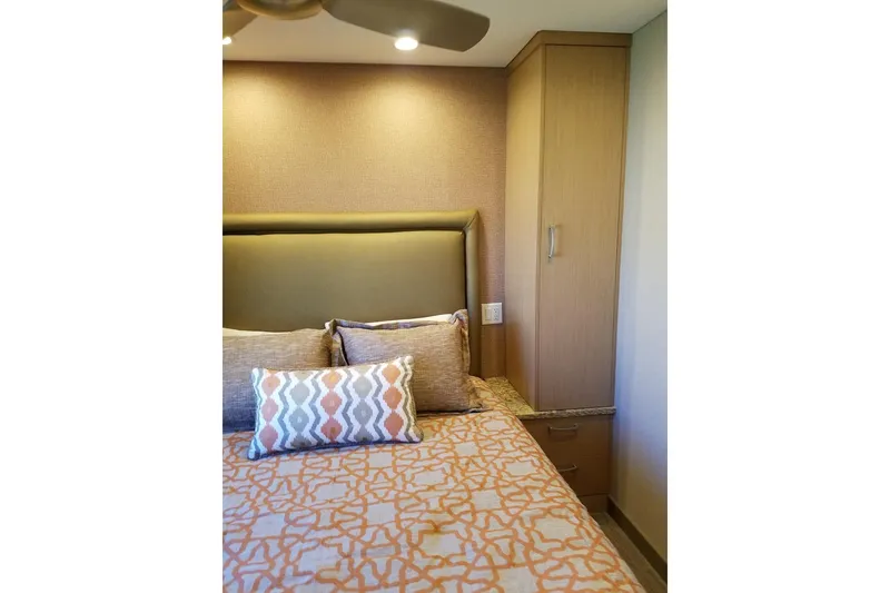 Slide: The Image of Cozy bedroom with patterned bedding, cushioned headboard, and wooden cabinet, Adonia 7518, 2017. - 21