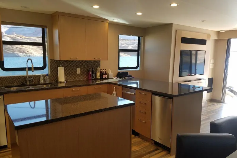 Slide: The Image of Modern kitchen interior on Adonia 7518 houseboat, featuring sleek countertops and scenic window views. - 6