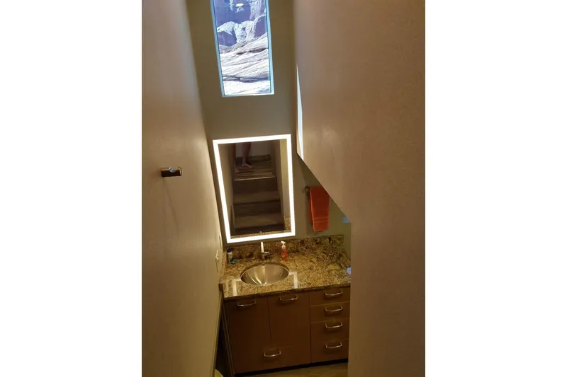 Slide: The Image of Modern bathroom with granite countertop, illuminated mirror, and small window. Adonia 7518, 2017 model. - 7