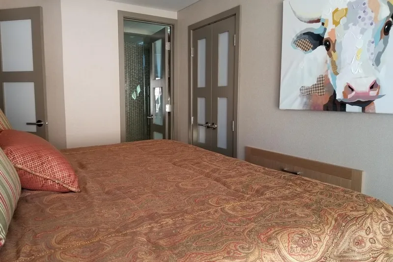 Slide: The Image of Cozy bedroom with patterned bedding, abstract cow artwork, and modern decor in Adonia 7518 model. - 8