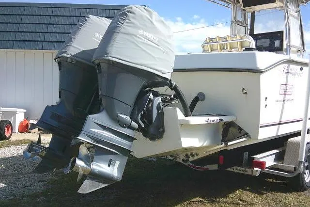 Slide: The Image of 2002 KenCraft Challenger 235 CC boat with dual outboard motors on a trailer. - 10