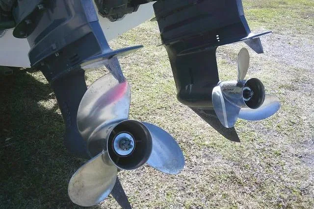 Slide: The Image of Twin propellers of a 2002 KenCraft Challenger 235 CC boat on grass. - 12