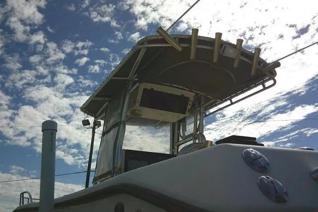 Slide: The Image of 2002 KenCraft Challenger 235 CC boat against a cloudy sky backdrop. - 13