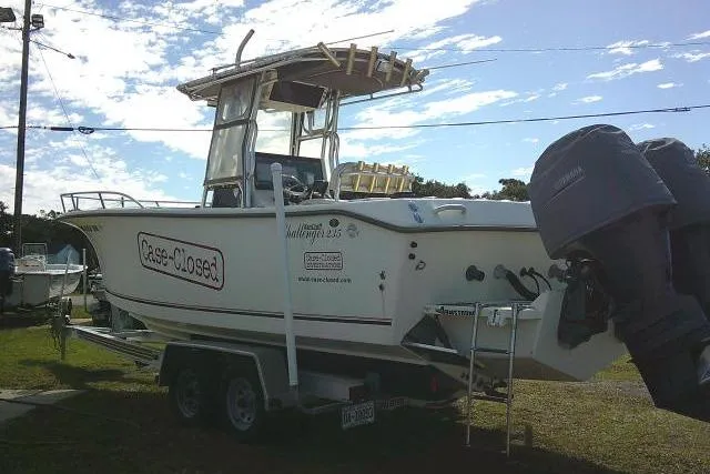 Slide: The Image of 2002 KenCraft Challenger 235 CC boat on trailer, outdoor setting, overcast sky. - 14