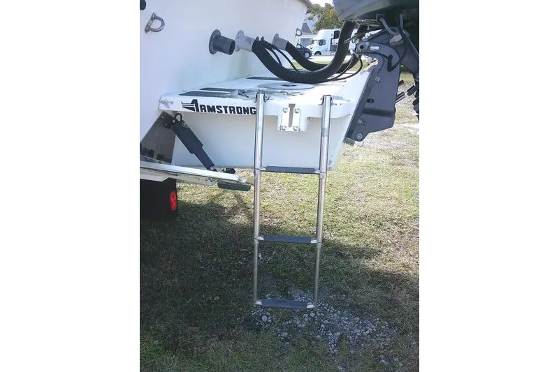 Slide: The Image of 2002 KenCraft Challenger 235 CC boat with Armstrong ladder on grassy area. - 15