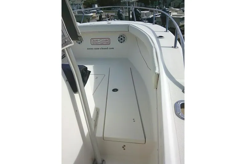 Slide: The Image of 2002 KenCraft Challenger 235 CC boat interior with seating and storage compartments. - 16