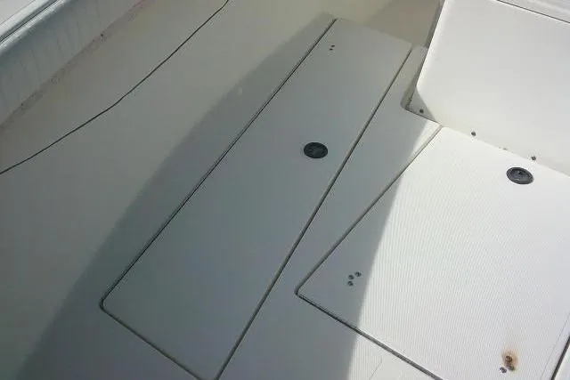 Slide: The Image of Deck view of 2002 KenCraft Challenger 235 CC boat, featuring storage compartments. - 19