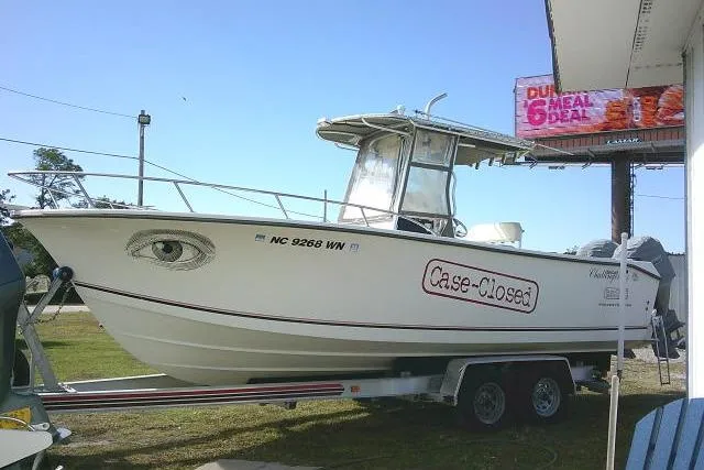 Slide: The Image of 2002 KenCraft Challenger 235 CC boat on trailer with "Case-Closed" text and eye graphic. - 2