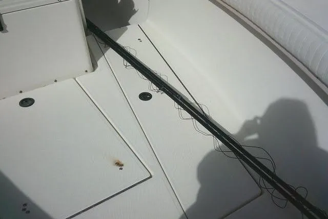 Slide: The Image of 2002 KenCraft Challenger 235 CC boat deck with visible wiring and storage compartments. - 20