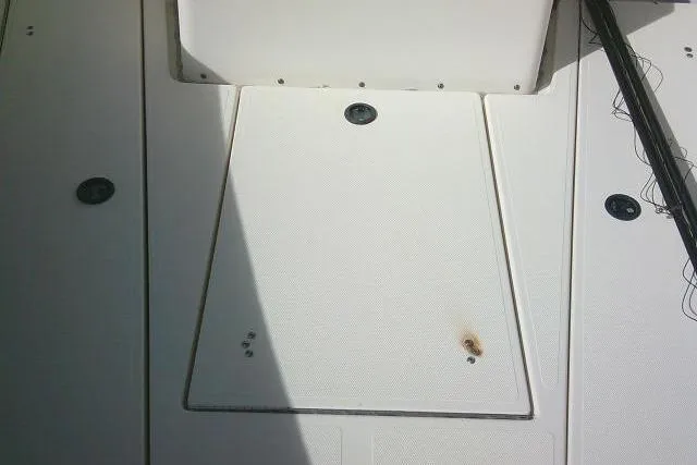 Slide: The Image of Deck of 2002 KenCraft Challenger 235 CC boat with storage hatch and slight rust mark. - 21