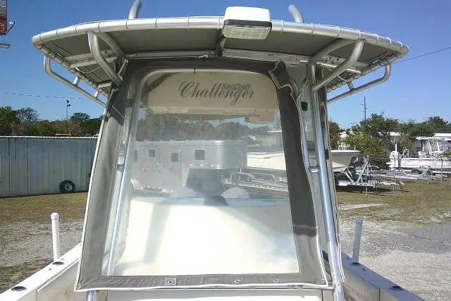 Slide: The Image of 2002 KenCraft Challenger 235 CC boat with protective cover, parked outdoors. - 23