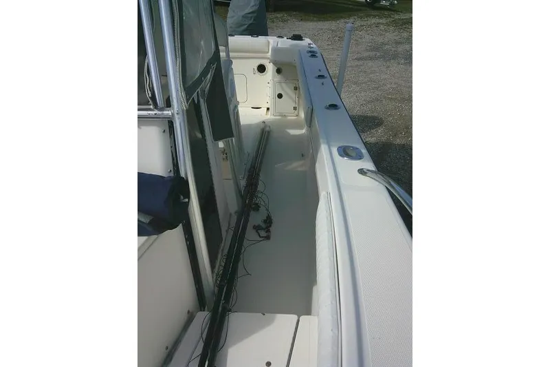 Slide: The Image of 2002 KenCraft Challenger 235 CC boat interior with fishing rods and storage compartments. - 25