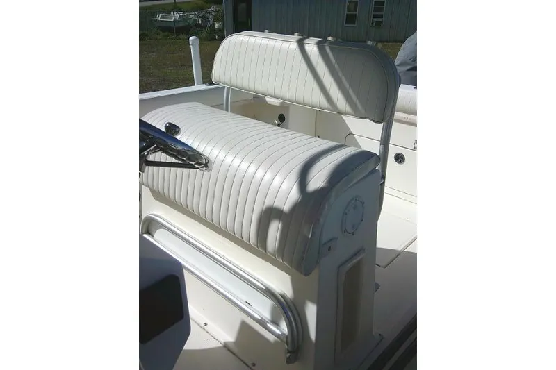 Slide: The Image of 2002 KenCraft Challenger 235 CC boat seat with white upholstery and steering wheel. - 28
