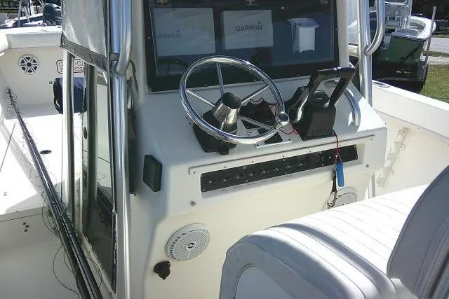 Slide: The Image of 2002 KenCraft Challenger 235 CC boat console with steering wheel and Garmin navigation system. - 29