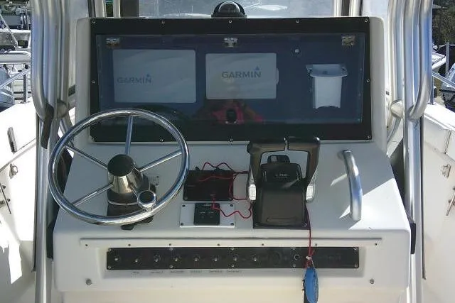 Slide: The Image of 2002 KenCraft Challenger 235 CC helm with Garmin displays and steering wheel. - 31