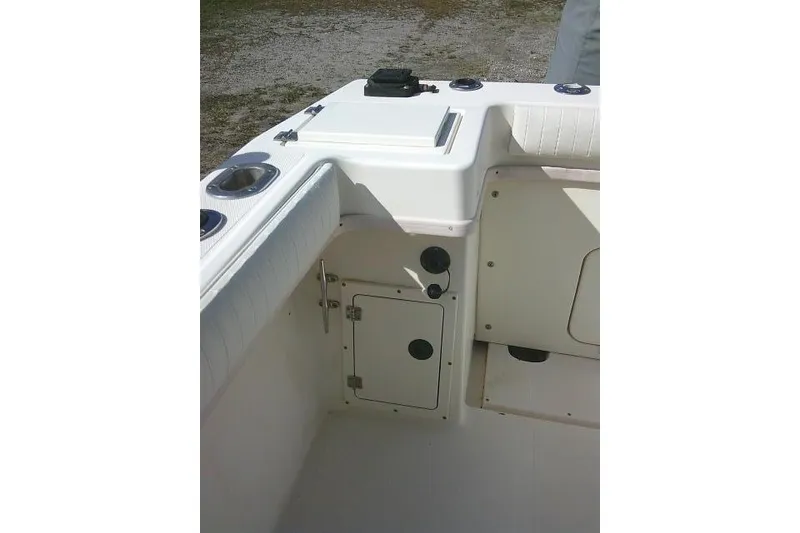 Slide: The Image of 2002 KenCraft Challenger 235 CC boat interior with storage compartments and cup holders. - 34