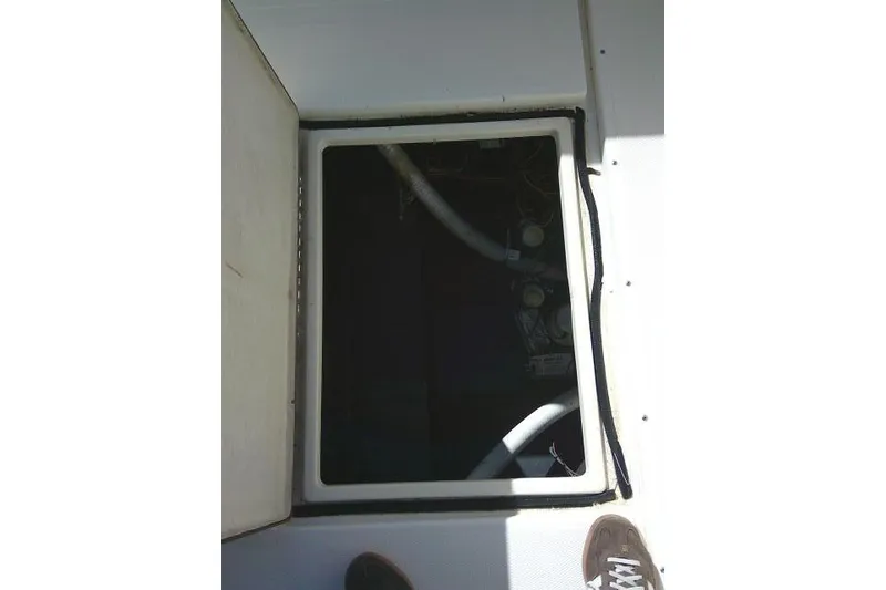 Slide: The Image of Open hatch on 2002 KenCraft Challenger 235 CC boat deck, revealing interior components. - 37