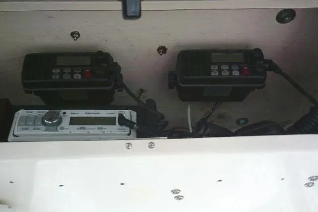 Slide: The Image of 2002 KenCraft Challenger 235 CC electronics panel with communication devices and radio equipment. - 42