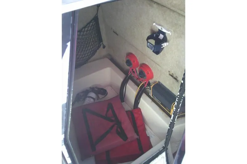 Slide: The Image of 2002 KenCraft Challenger 235 CC interior with safety equipment and storage. - 43