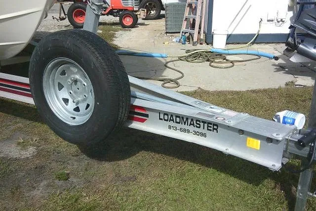Slide: The Image of Trailer for 2002 KenCraft Challenger 235 CC boat, featuring Loadmaster branding. - 6