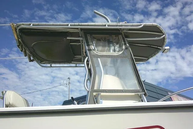 Slide: The Image of 2002 KenCraft Challenger 235 CC boat with T-top against a blue sky. - 7