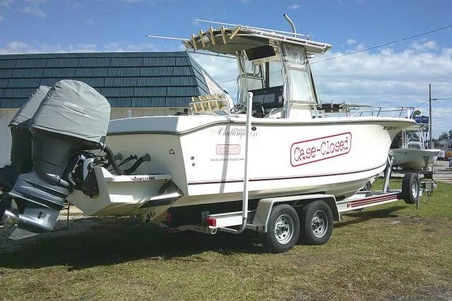 Slide: The Image of 2002 KenCraft Challenger 235 CC boat on trailer, named "Case-Closed," with dual outboard motors. - 8