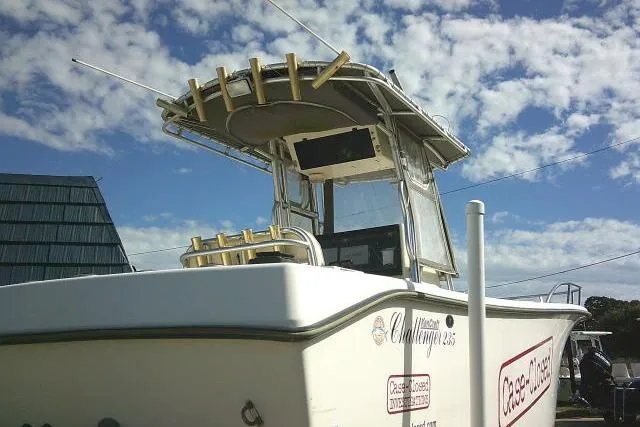 Slide: The Image of 2002 KenCraft Challenger 235 CC boat with T-top and rod holders under a blue sky. - 9