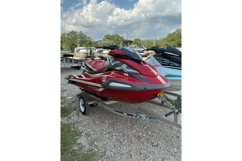 Slide: The Image of 2023 Yamaha WaveRunner VX in red on a trailer, parked outdoors under a cloudy sky. - 3