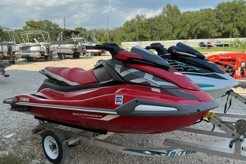 Slide: The Image of 2023 Yamaha WaveRunner VX in red on trailer, parked outdoors. - 5