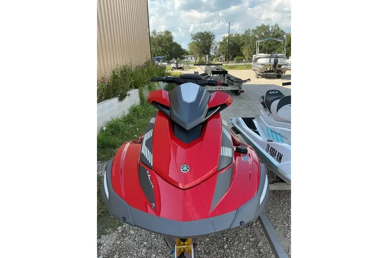 Slide: The Image of 2023 Yamaha WaveRunner VX in red, parked outdoors on gravel. - 7