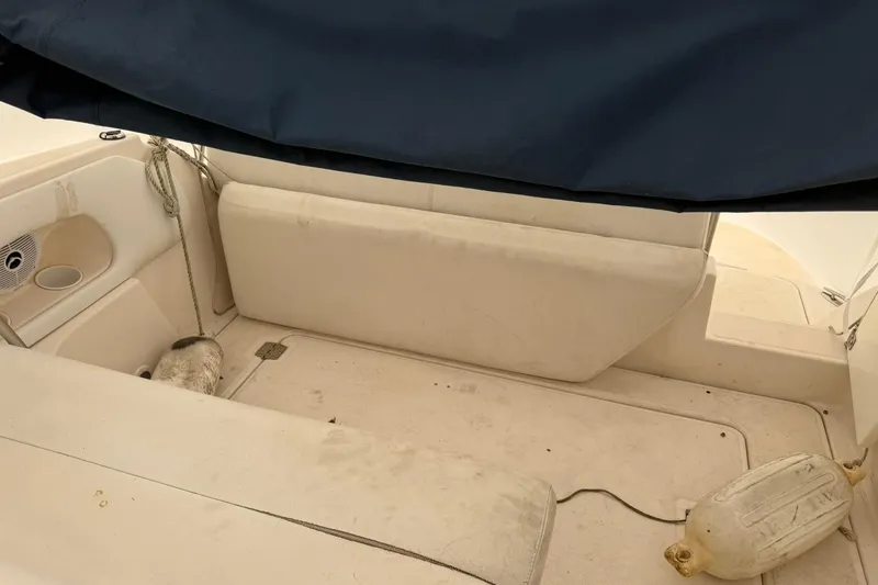 Slide: The Image of 2005 Regal Commodore 265 boat interior with seating and protective cover. - 11