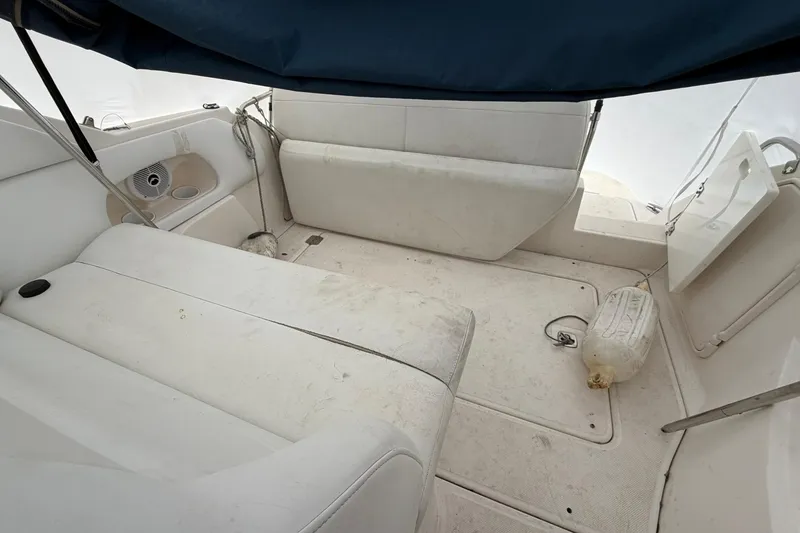 Slide: The Image of 2005 Regal Commodore 265 boat interior with white seating and canopy. - 12