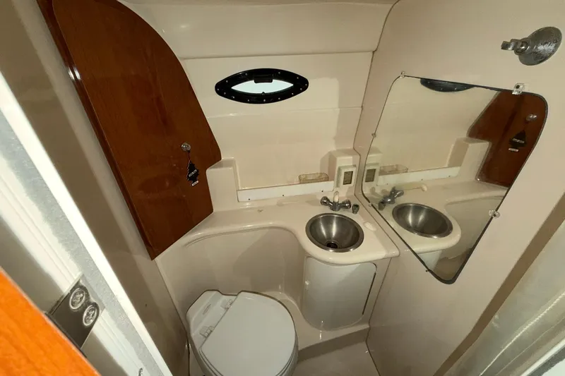 Slide: The Image of 2005 Regal Commodore 265 boat bathroom with sink, mirror, and toilet. - 18