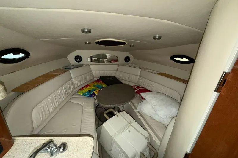 Slide: The Image of 2005 Regal Commodore 265 cabin interior with seating, table, and portholes. - 19