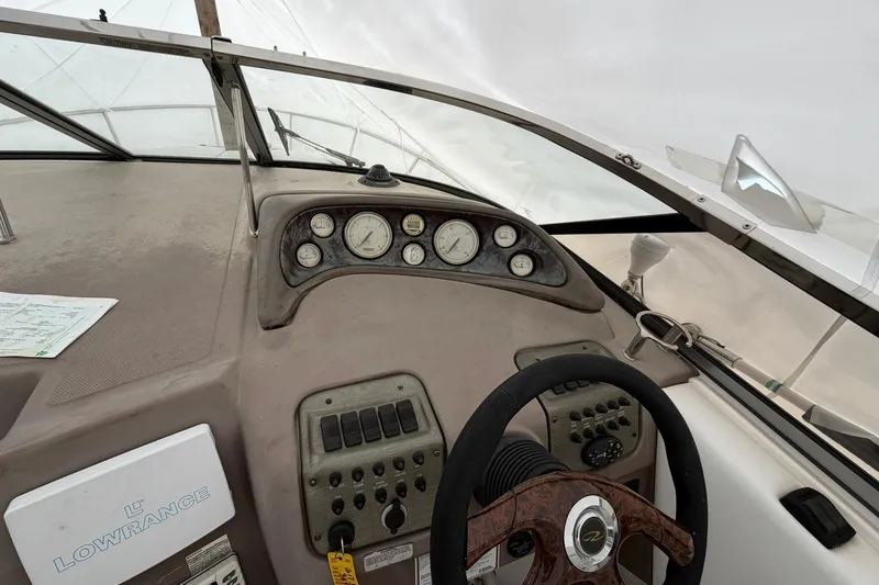 Slide: The Image of 2005 Regal Commodore 265 boat dashboard with steering wheel and instrument panel. - 23