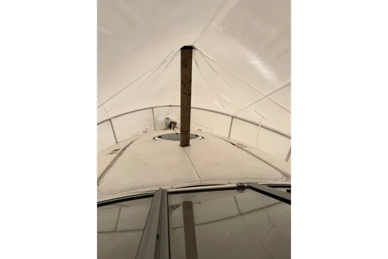 Slide: The Image of 2005 Regal Commodore 265 boat under protective cover, viewed from the bow. - 24