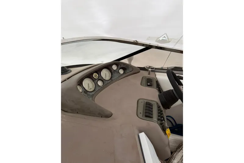 Slide: The Image of Dashboard of a 2005 Regal Commodore 265 boat with gauges and steering wheel. - 25
