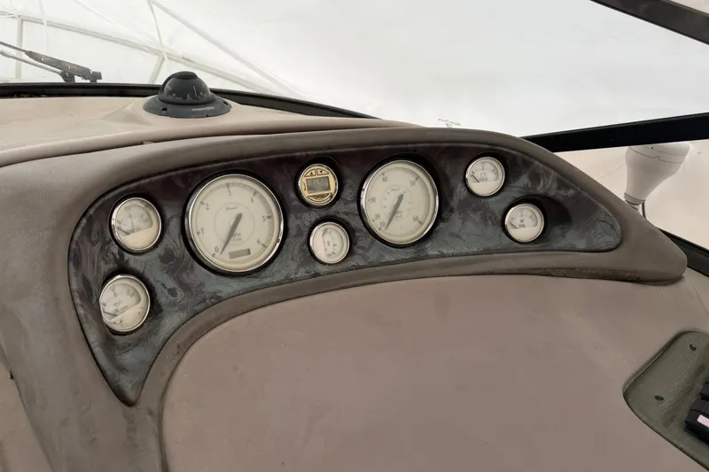 Slide: The Image of Dashboard of a 2005 Regal Commodore 265 boat with multiple gauges and instruments. - 26