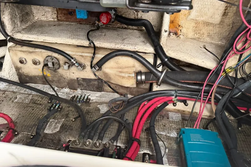 Slide: The Image of Engine compartment of a 2005 Regal Commodore 265 with visible wiring and components. - 31