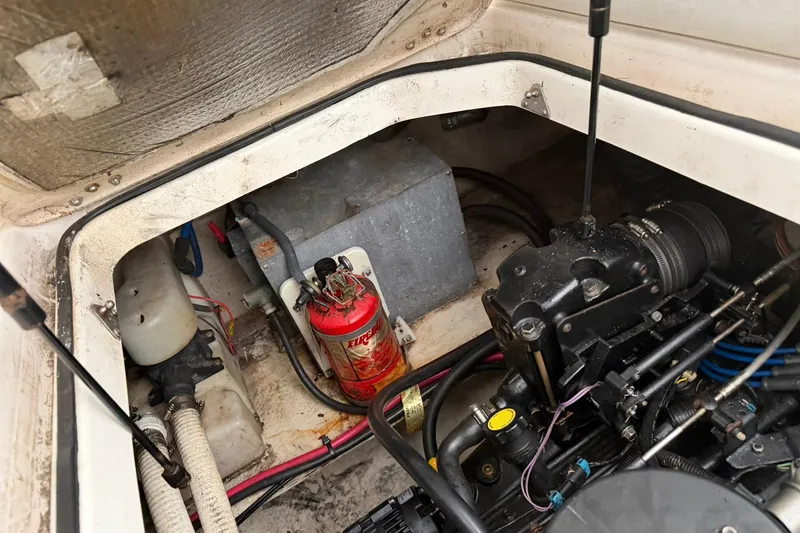 Slide: The Image of Engine compartment of 2005 Regal Commodore 265 boat with fire extinguisher and mechanical components. - 32