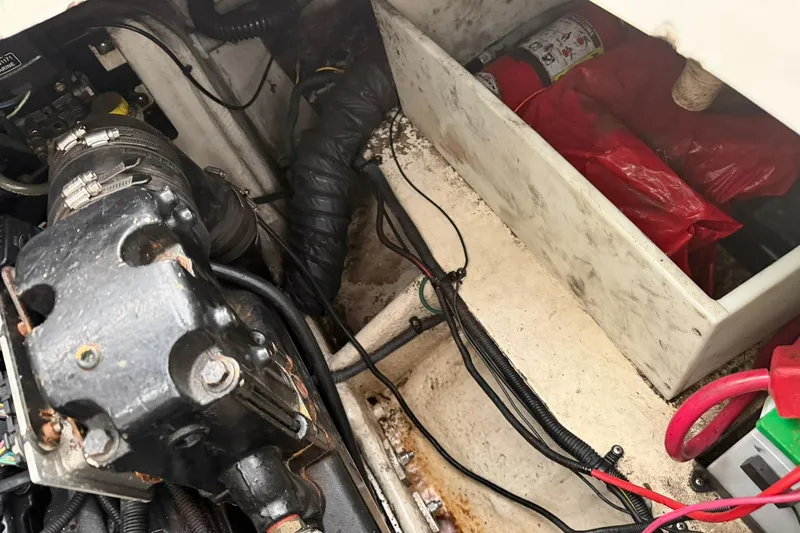 Slide: The Image of Engine compartment of 2005 Regal Commodore 265 with visible wiring and fire extinguisher. - 33