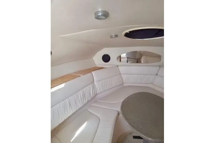 Slide: The Image of 2005 Regal Commodore 265 interior with white seating and round table. - 6