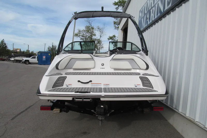 Slide: The Image of 2016 Yamaha Boats AR192, rear view, parked outside a marine store. - 4