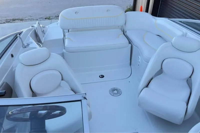 Slide: The Image of 2005 Crownline 220 EX boat interior with white seating and steering wheel. - 5