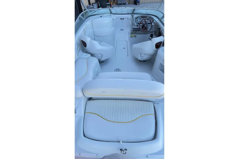 Slide: The Image of 2005 Crownline 220 EX boat interior with white seating and steering wheel. - 9