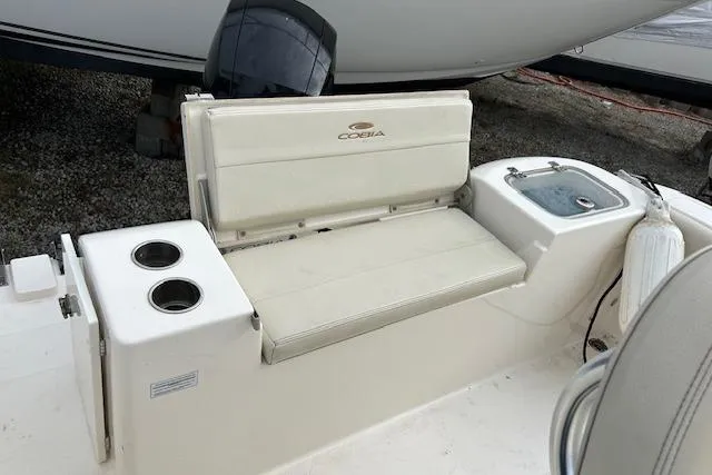 Slide: The Image of 2023 Cobia 220DC boat interior with seating and cup holders. - 4