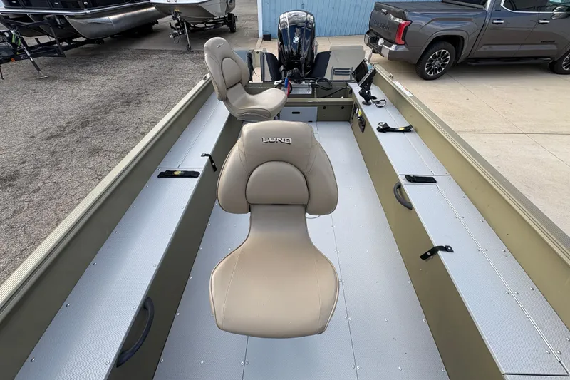 Slide: The Image of 2022 Lund 1800 Alaskan Tiller boat interior with beige seats and modern design. - 14