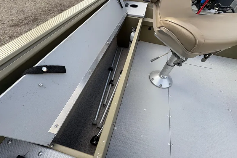 Slide: The Image of 2022 Lund 1800 Alaskan Tiller boat interior with storage compartment and swivel seat. - 20