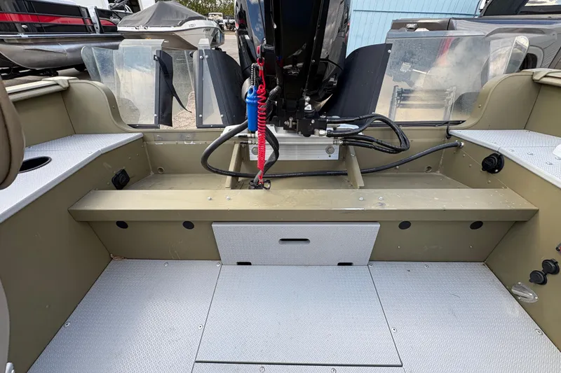 Slide: The Image of 2022 Lund 1800 Alaskan Tiller boat interior with motor and seating area. - 21